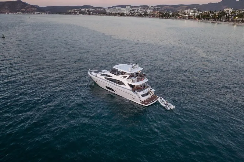 Slide: The Image of Luxurious 2012 Sunseeker Manhattan 73 yacht cruising on serene coastal waters. - 5