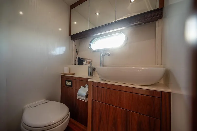 Slide: The Image of Luxurious bathroom in 2012 Sunseeker Manhattan 73 yacht with modern fixtures and wood cabinetry. - 54