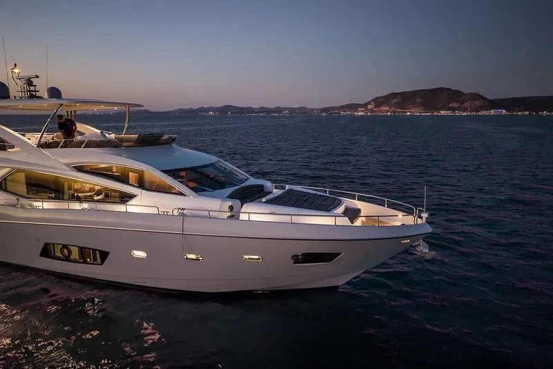Slide: The Image of Luxurious 2012 Sunseeker Manhattan 73 yacht cruising at sunset on serene waters. - 6
