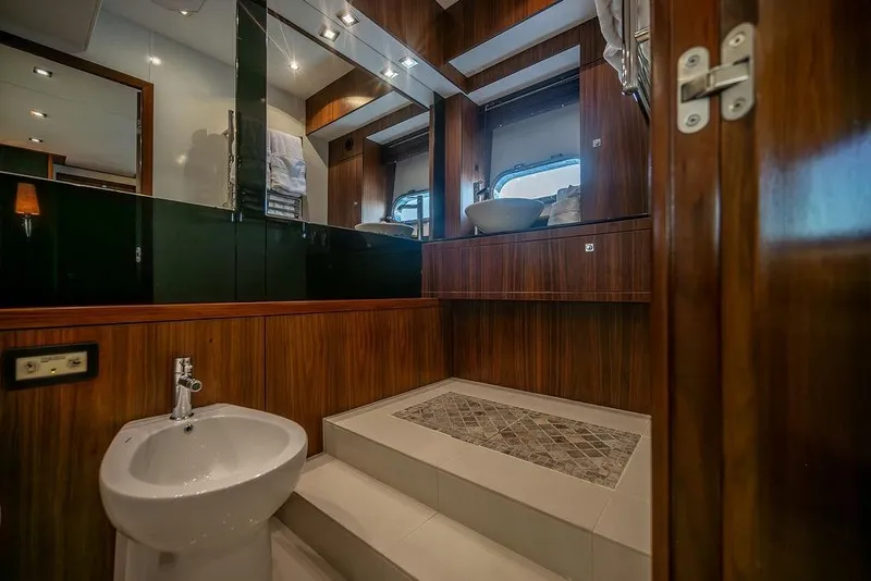 Slide: The Image of Luxurious bathroom interior on 2012 Sunseeker Manhattan 73 yacht, featuring elegant wood finishes. - 67