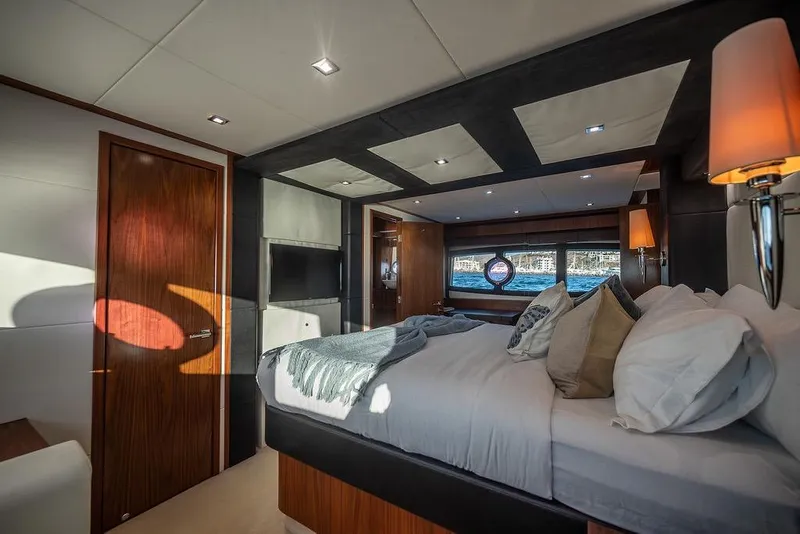 Slide: The Image of Luxurious bedroom interior on 2012 Sunseeker Manhattan 73 yacht, featuring elegant decor and ocean view. - 72