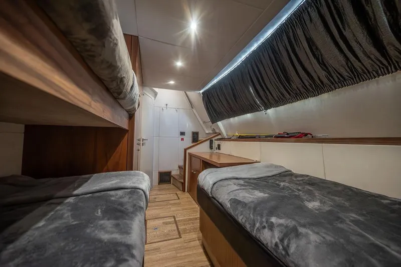 Slide: The Image of Luxurious cabin interior of 2012 Sunseeker Manhattan 73 yacht with twin beds and elegant decor. - 77