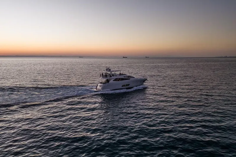 Slide: The Image of Luxurious 2012 Sunseeker Manhattan 73 yacht cruising at sunset on open sea. - 8