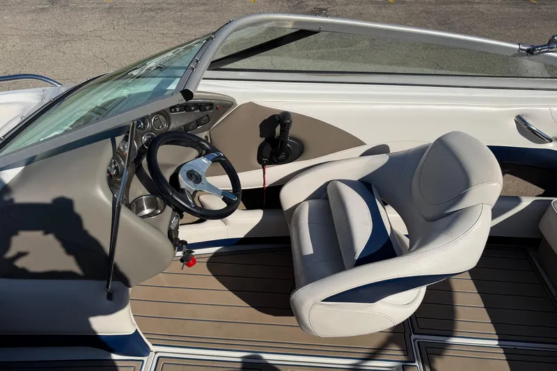 Slide: The Image of 2011 Crownline 21 SS boat interior with steering wheel and captain's chair. - 13