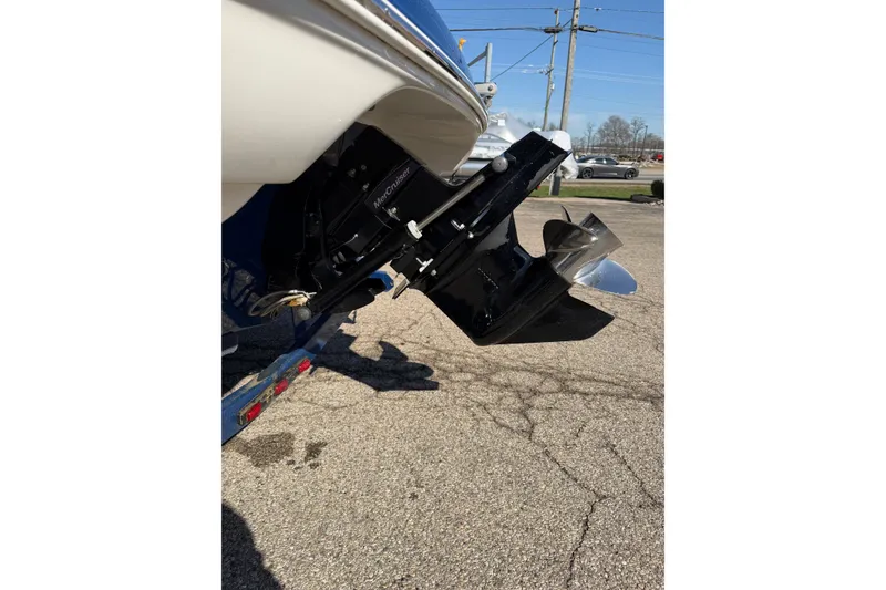 Slide: The Image of 2011 Crownline 21 SS boat with MerCruiser outdrive, parked on pavement. - 14