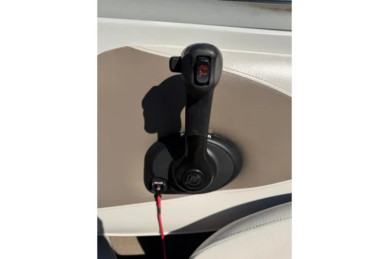 Slide: The Image of Throttle control lever on a 2011 Crownline 21 SS boat, featuring a sleek design. - 16