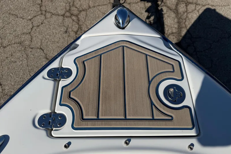 Slide: The Image of Bow of 2011 Crownline 21 SS boat with textured deck and metal fittings. - 2