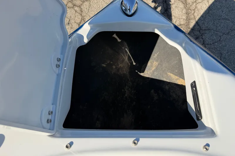 Slide: The Image of Open storage compartment on a 2011 Crownline 21 SS boat, showing interior space. - 3