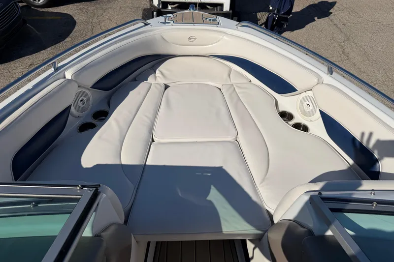 Slide: The Image of 2011 Crownline 21 SS boat interior with white cushioned seating and cup holders. - 6