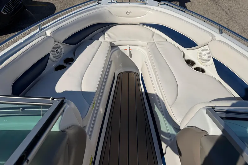 Slide: The Image of 2011 Crownline 21 SS boat interior with white seating and cup holders. - 7