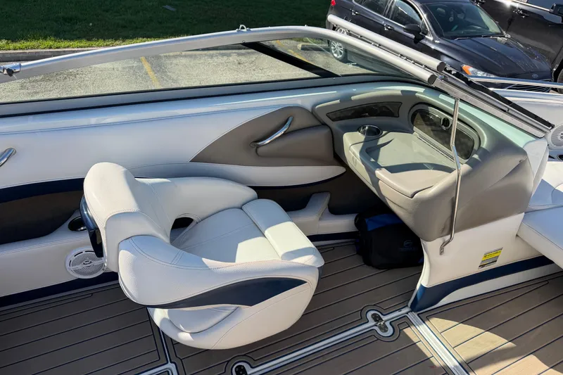 Slide: The Image of 2011 Crownline 21 SS boat interior with white seating and sleek dashboard design. - 8