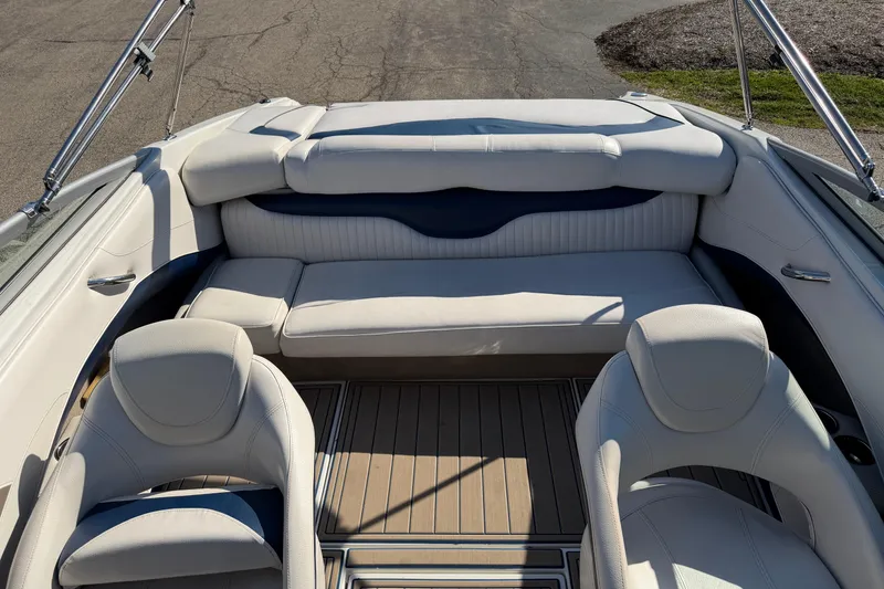 Slide: The Image of 2011 Crownline 21 SS boat interior with white seating and wooden flooring. - 9