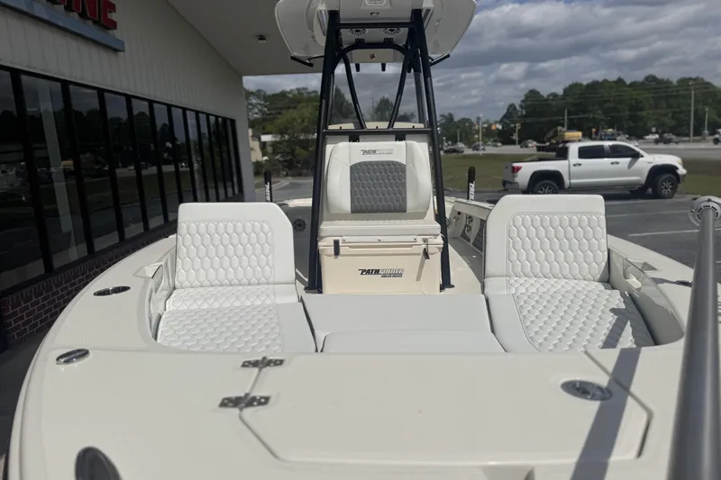 Slide: The Image of 2026 Pathfinder 2600 TRS boat with white seating, parked outdoors. - 11