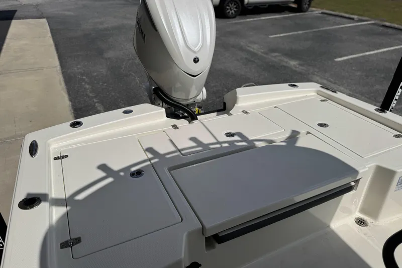 Slide: The Image of 2026 Pathfinder 2600 TRS boat deck with motor, parked on pavement. - 14