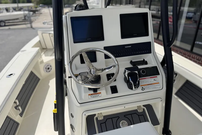 Slide: The Image of 2026 Pathfinder 2600 TRS boat console with dual screens and steering wheel. - 17
