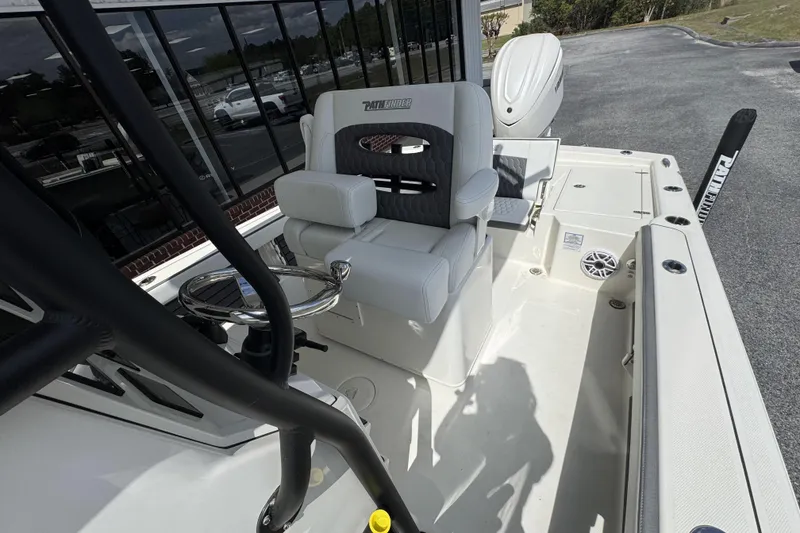 Slide: The Image of 2026 Pathfinder 2600 TRS boat interior with seating and steering wheel. - 21