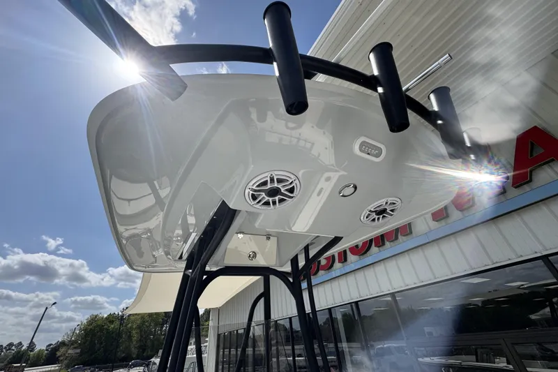 Slide: The Image of 2026 Pathfinder 2600 TRS boat with T-top speakers and rod holders under sunny sky. - 23