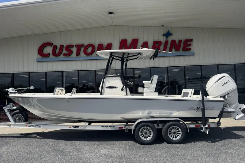 Slide: The Image of 2026 Pathfinder 2600 TRS boat on trailer at Custom Marine dealership. - 24