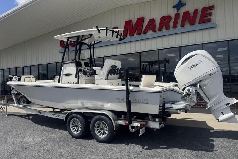 Slide: The Image of 2026 Pathfinder 2600 TRS boat with Yamaha engine on trailer outside marine store. - 25