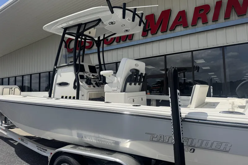 Slide: The Image of 2026 Pathfinder 2600 TRS boat displayed at Custom Marine dealership. - 26