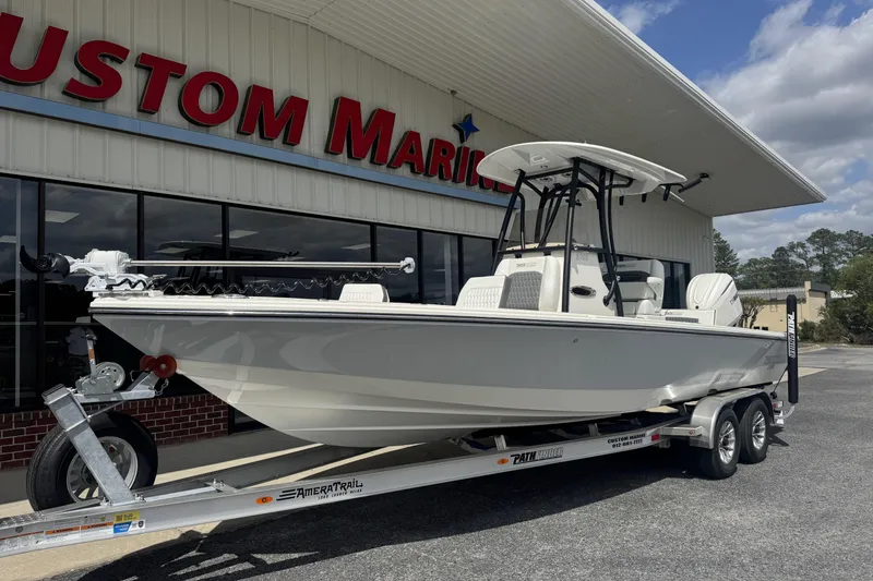 Slide: The Image of 2026 Pathfinder 2600 TRS boat on trailer outside Custom Marine dealership. - 28