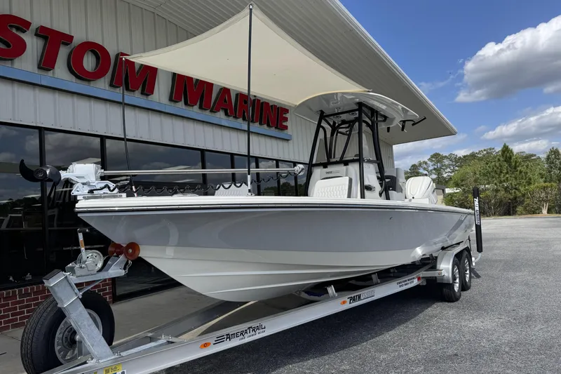 Slide: The Image of 2026 Pathfinder 2600 TRS boat on trailer outside marine dealership. - 3