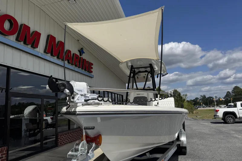 Slide: The Image of 2026 Pathfinder 2600 TRS boat displayed outside marine dealership under blue sky. - 4