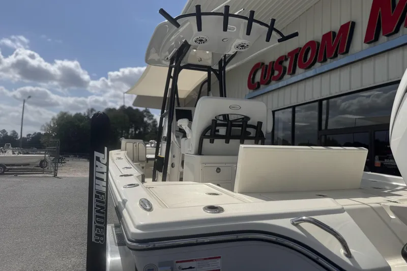 Slide: The Image of 2026 Pathfinder 2600 TRS boat displayed outside a custom marine shop. - 8