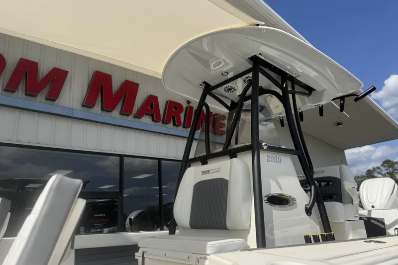 Slide: The Image of 2026 Pathfinder 2600 TRS boat displayed at a marine dealership under a clear sky. - 9