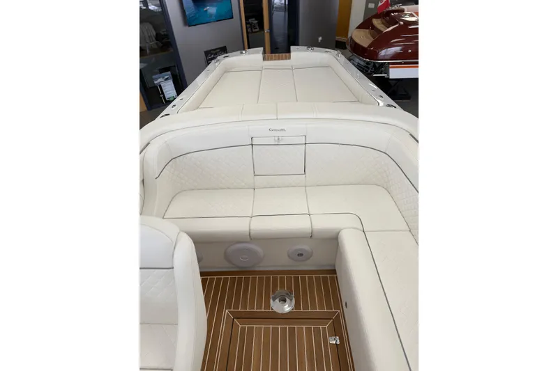Slide: The Image of 2024 Comitti Venezia V28 luxury boat interior with white seating and wooden flooring. - 16