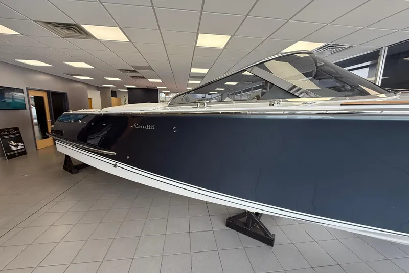 Slide: The Image of 2024 Comitti Venezia V28 luxury boat displayed indoors on a showroom floor. - 2