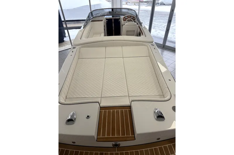Slide: The Image of 2024 Comitti Venezia V28 luxury boat with elegant white seating and wooden deck. - 4