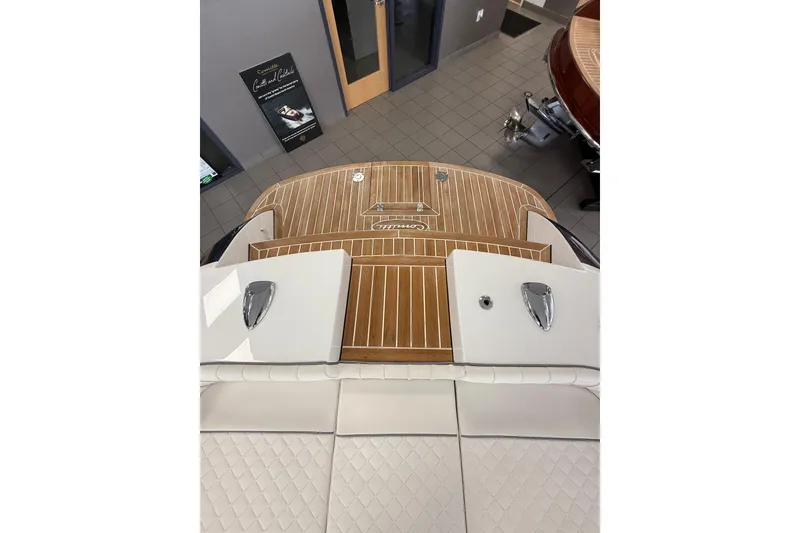 Slide: The Image of 2024 Comitti Venezia V28 boat with elegant teak deck and luxurious white seating. - 5