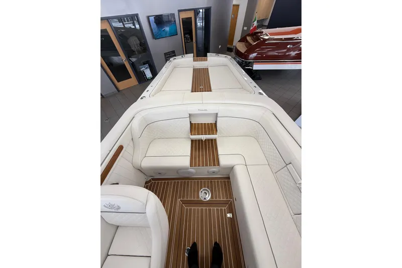 Slide: The Image of 2024 Comitti Venezia V28 luxury boat interior with elegant white seating and wooden flooring. - 6