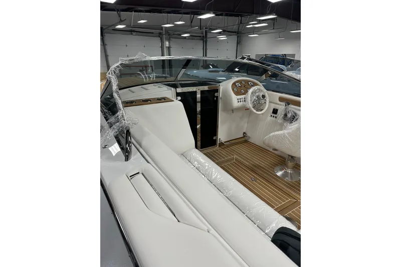 Slide: The Image of 2024 Comitti Venezia V28 boat interior with sleek white seating and modern dashboard. - 7