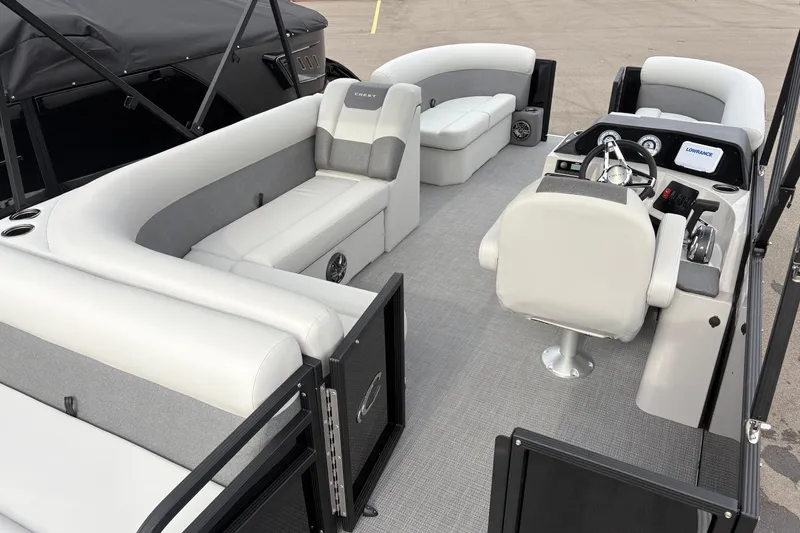 Slide: The Image of Interior of 2026 Crest 200SE pontoon boat with plush seating and modern helm. - 12