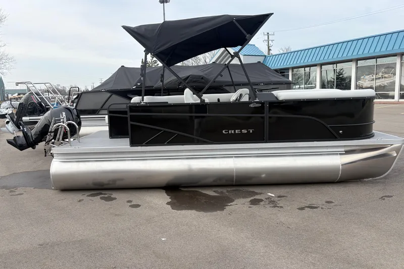 Slide: The Image of 2026 Crest 200SE pontoon boat with black canopy and sleek design. - 6