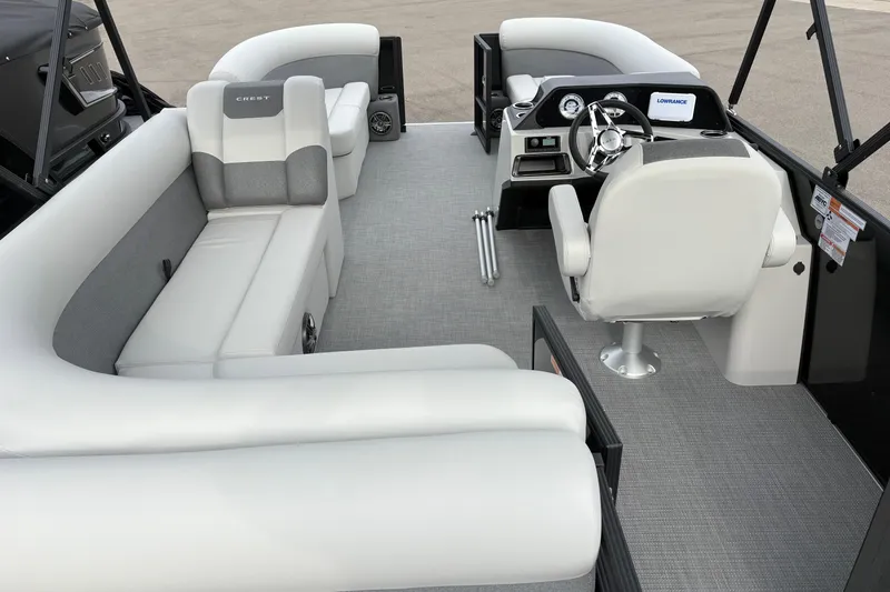 Slide: The Image of 2026 Crest 200SE boat interior with plush seating and modern dashboard. - 7