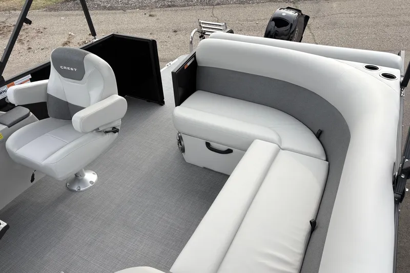 Slide: The Image of 2026 Crest 200SE boat interior with gray seating and captain's chair. - 8