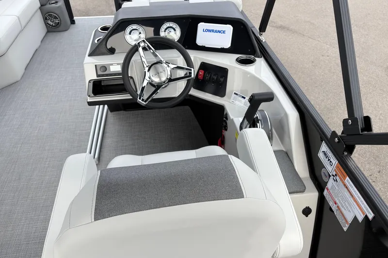 Slide: The Image of 2026 Crest 200SE boat helm with steering wheel, gauges, and navigation display. - 9