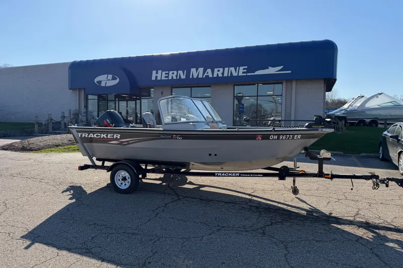 The Image of 2010 Tracker Pro Guide V-16 WT boat on trailer outside Hern Marine dealership. - 0