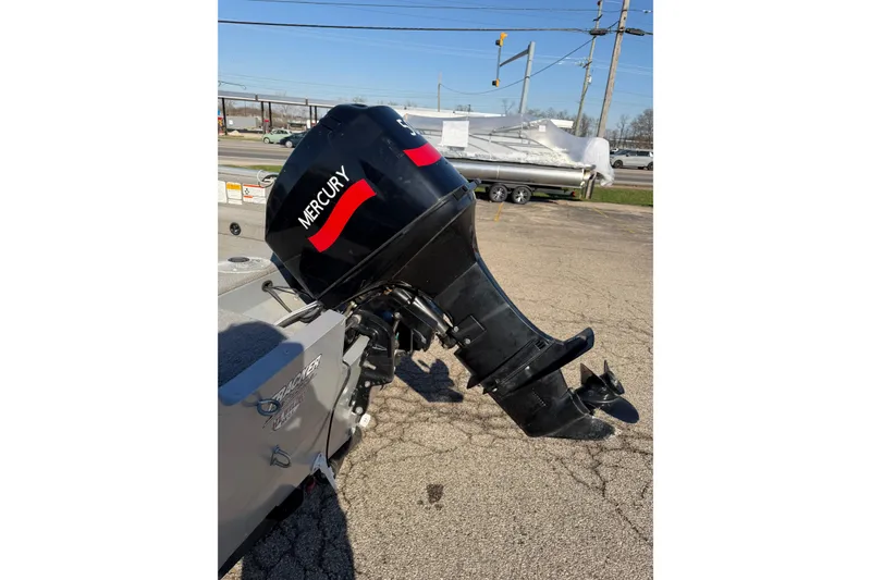 Slide: The Image of 2010 Tracker Pro Guide V-16 WT with Mercury outboard motor in parking lot. - 10