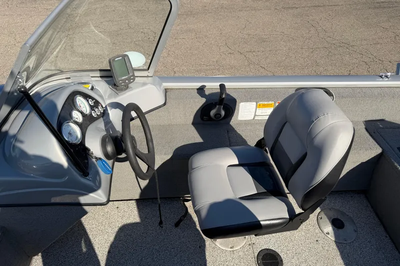 Slide: The Image of 2010 Tracker Pro Guide V-16 WT boat interior with steering wheel and seat. - 12