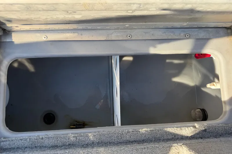 Slide: The Image of Open storage compartment in 2010 Tracker Pro Guide V-16 WT boat. - 13