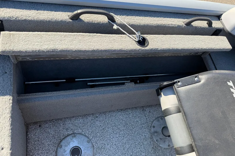 Slide: The Image of 2010 Tracker Pro Guide V-16 WT boat interior storage compartment with seat and handles. - 14