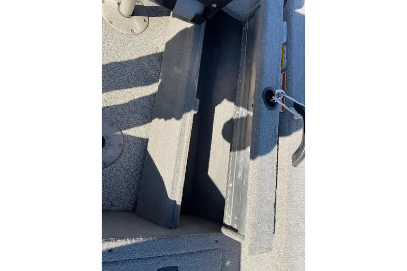 Slide: The Image of Interior view of a 2010 Tracker Pro Guide V-16 WT boat, showing storage compartment. - 15