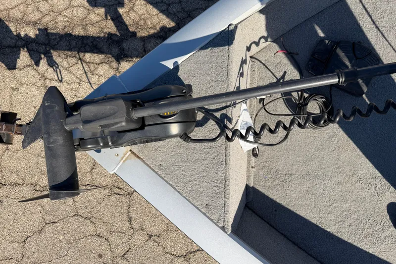 Slide: The Image of 2010 Tracker Pro Guide V-16 WT boat with trolling motor on textured surface. - 17