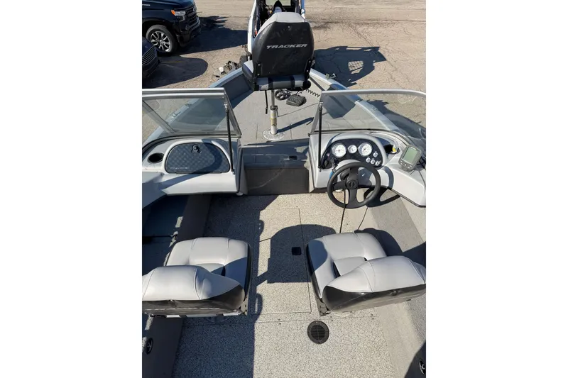 Slide: The Image of 2010 Tracker Pro Guide V-16 WT boat interior with steering wheel and seating. - 2
