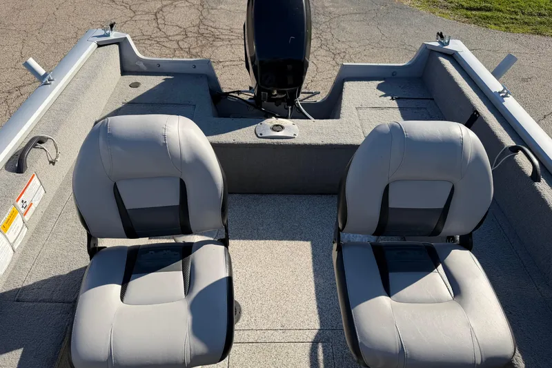 Slide: The Image of 2010 Tracker Pro Guide V-16 WT boat interior with two gray seats. - 7