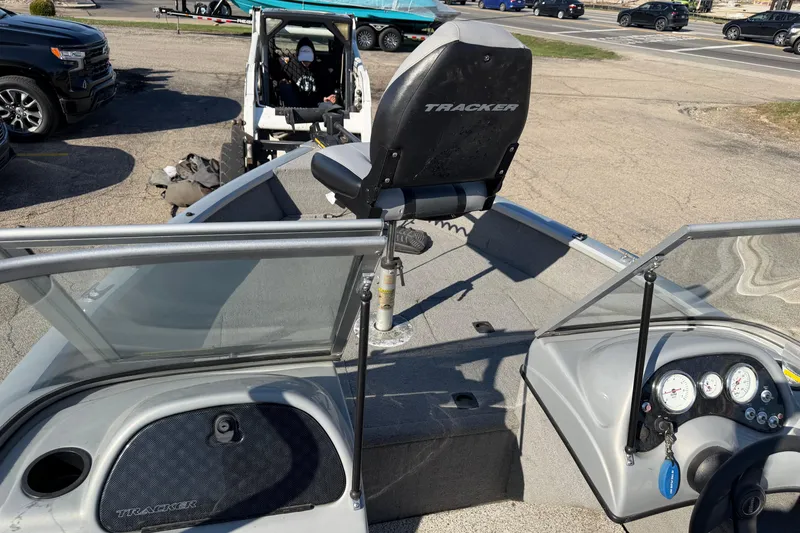 Slide: The Image of 2010 Tracker Pro Guide V-16 WT boat interior with steering console and seating. - 8
